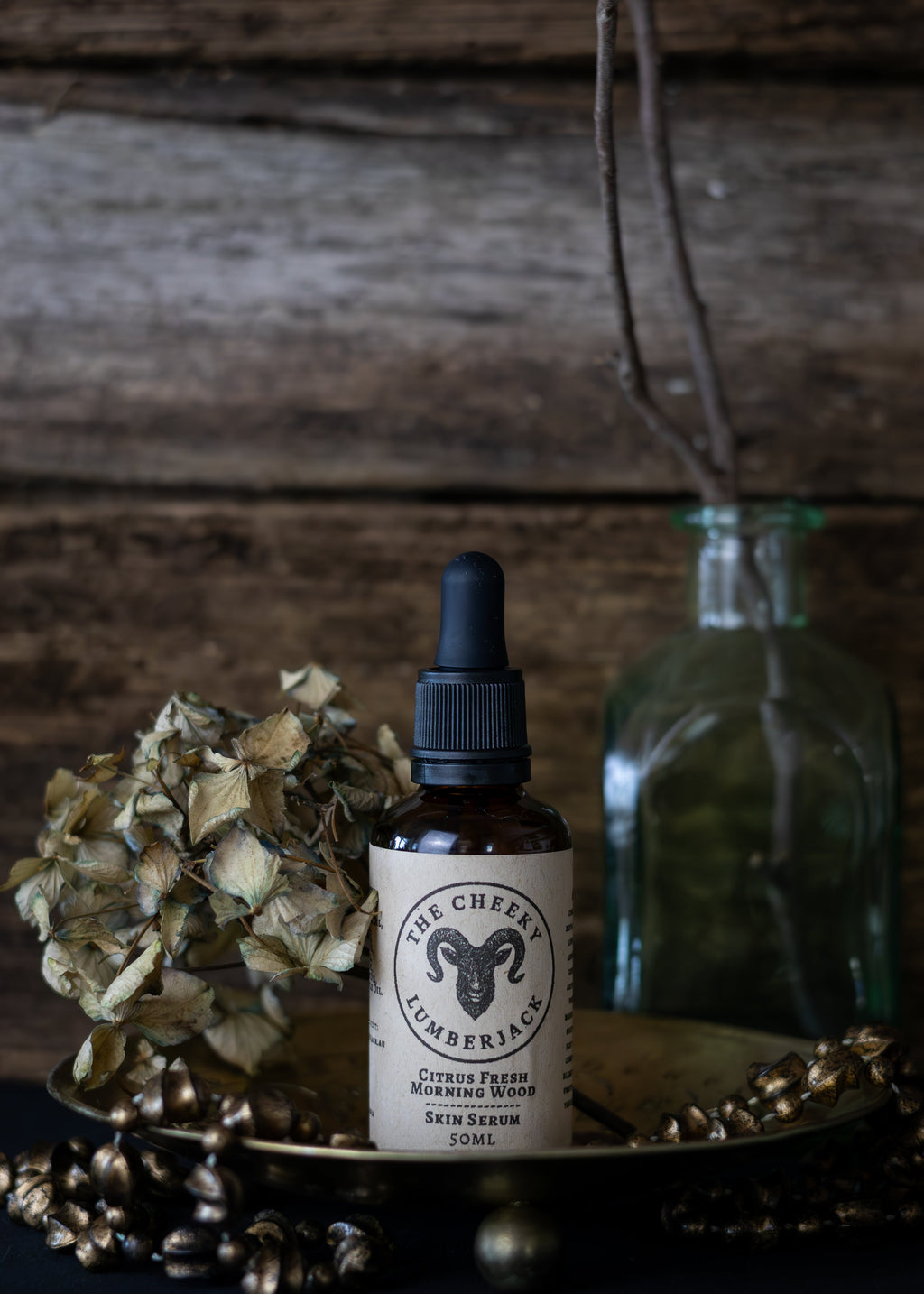 Bottle of skincare serum with dropper on a wooden surface