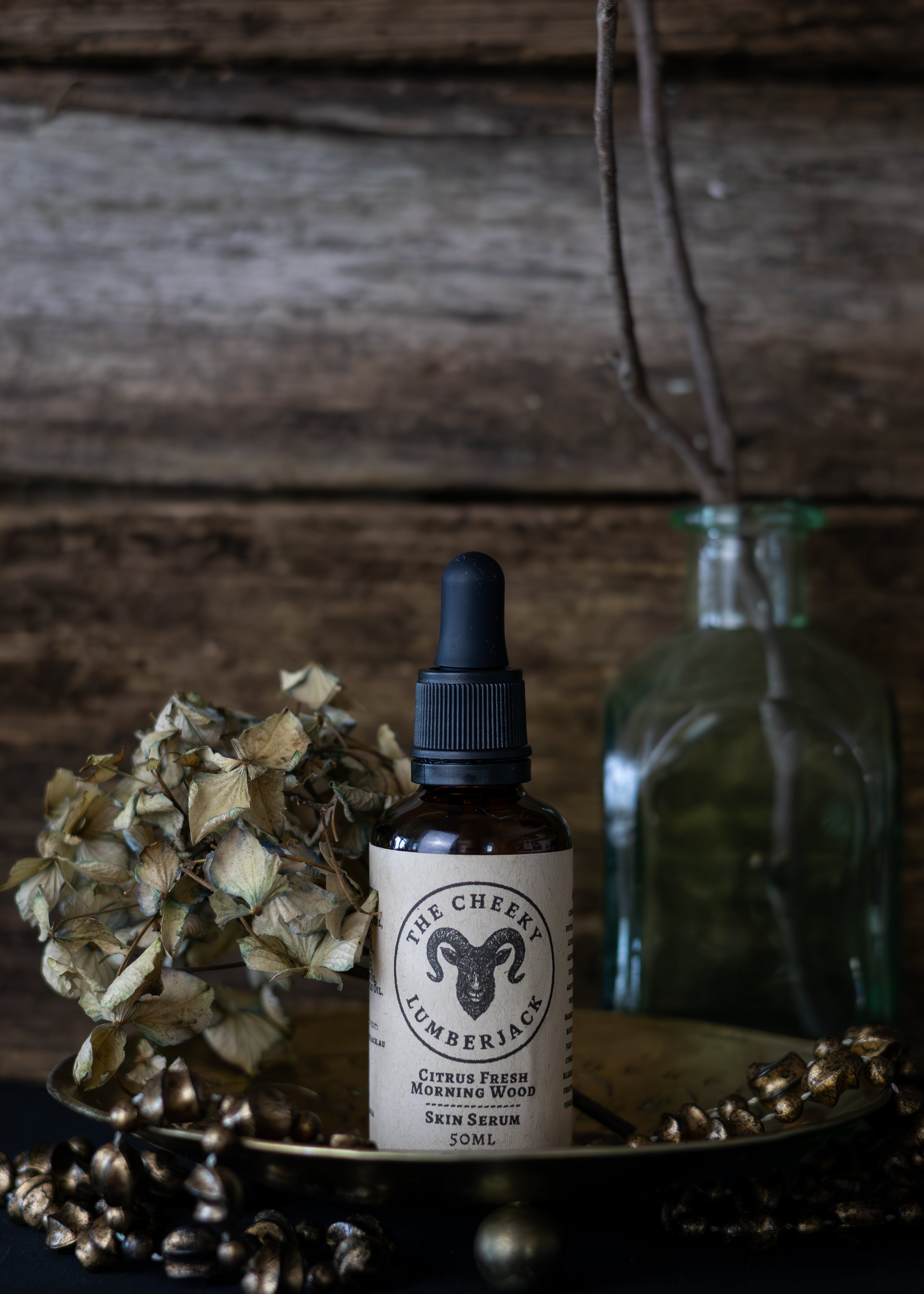 Bottle of skincare serum with dropper on a wooden surface