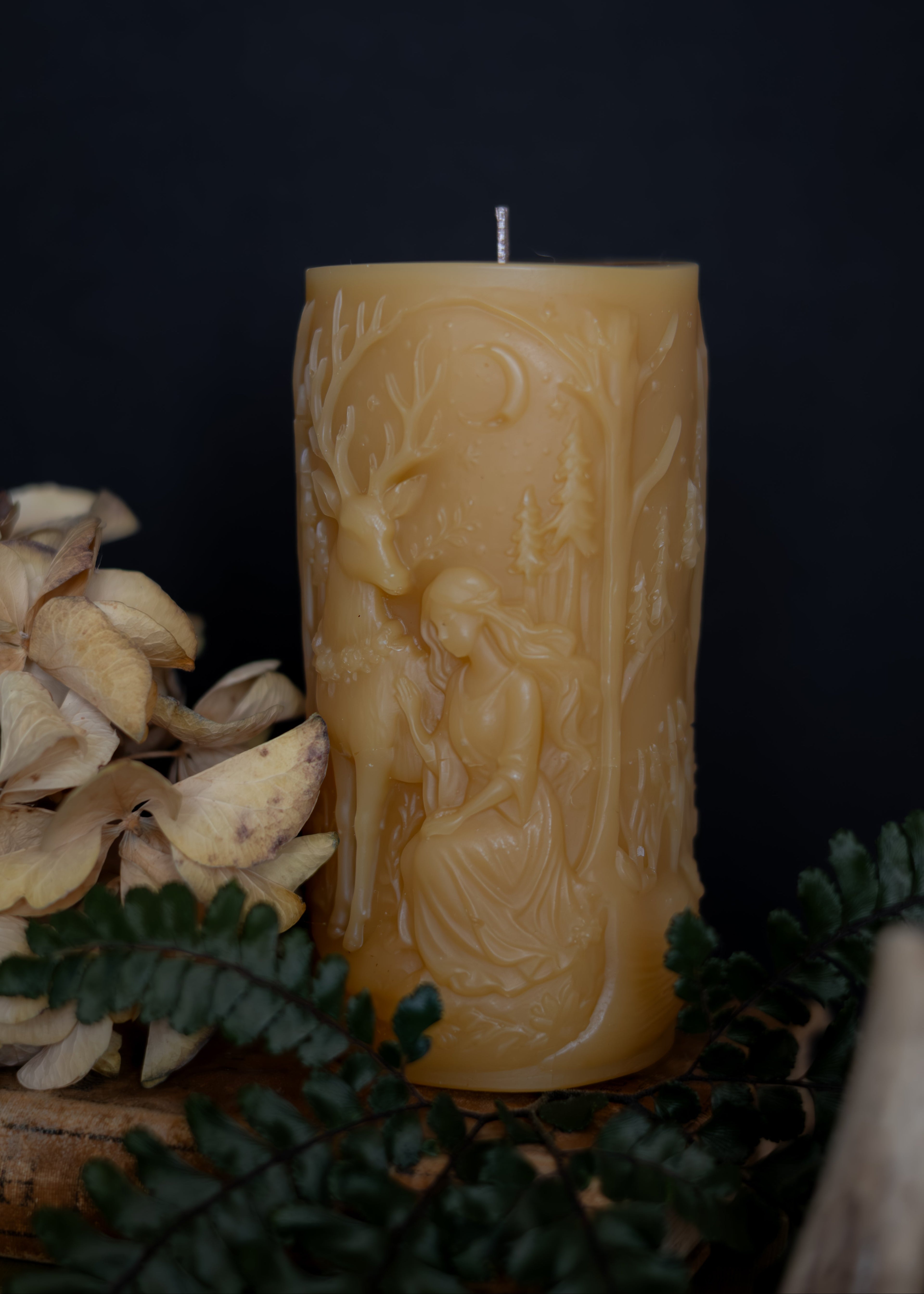 Decorative candle with intricate designs on a dark background