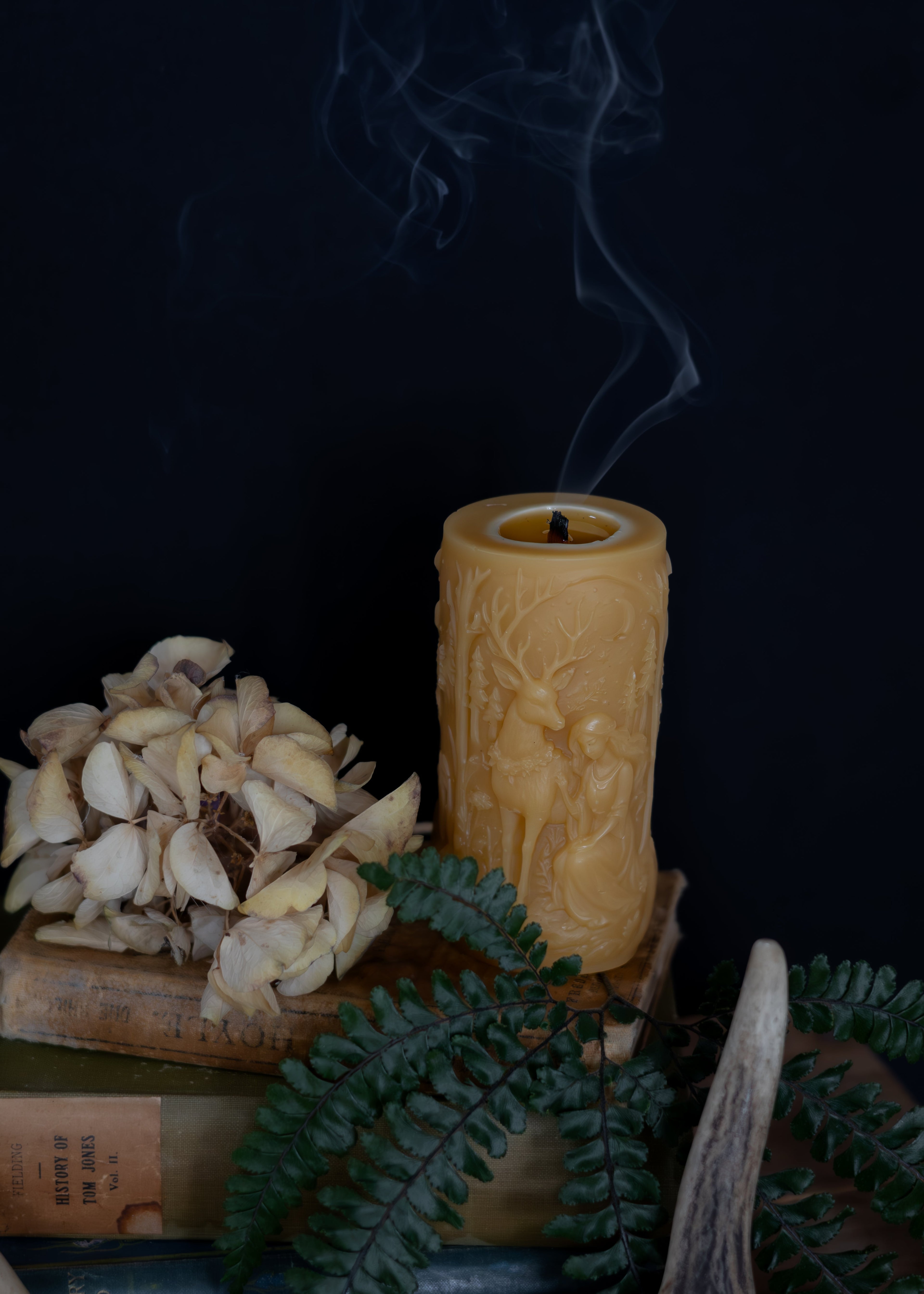 Decorative candle with intricate design on a dark background