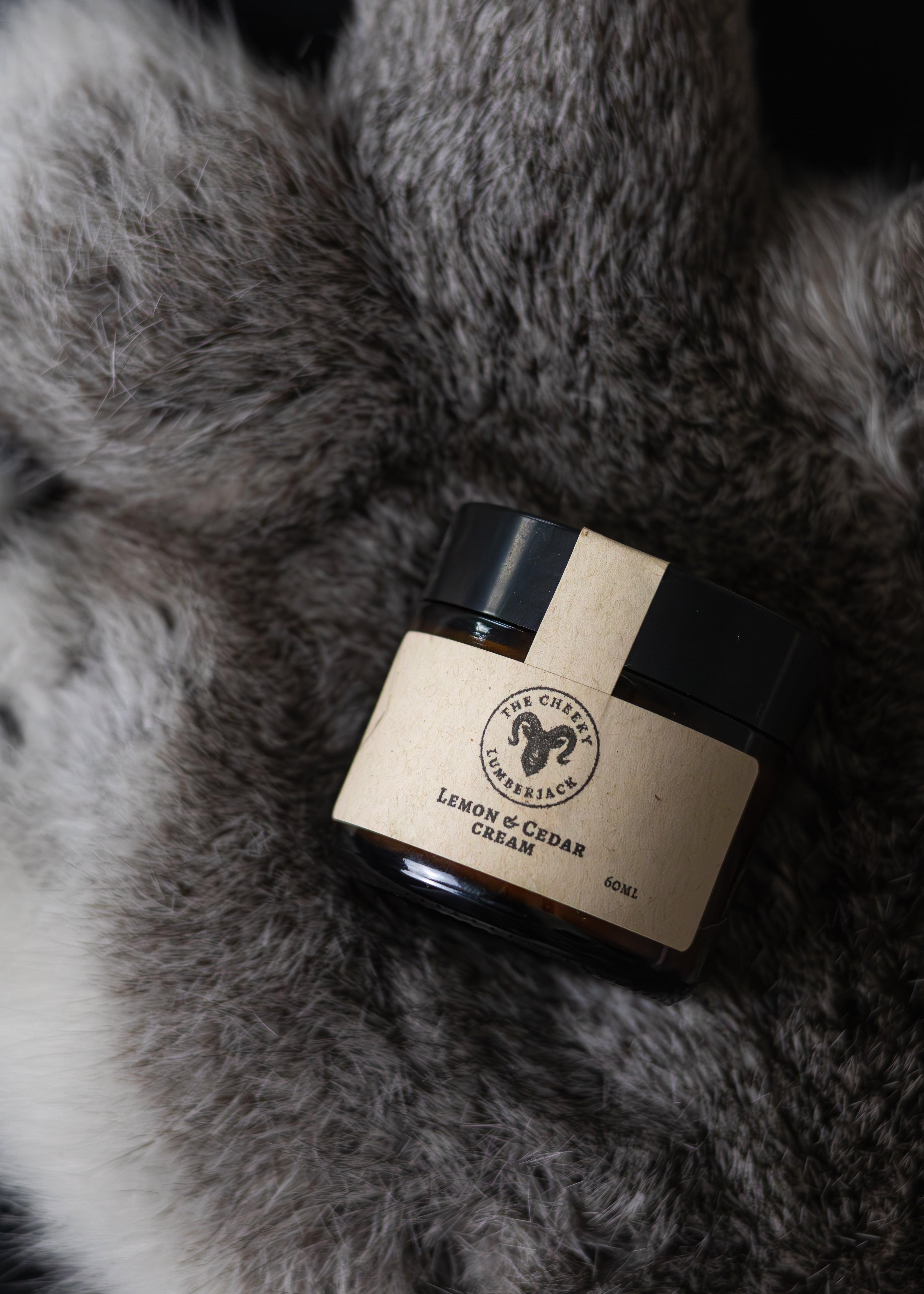 Jar of cream with a label on a fur surface