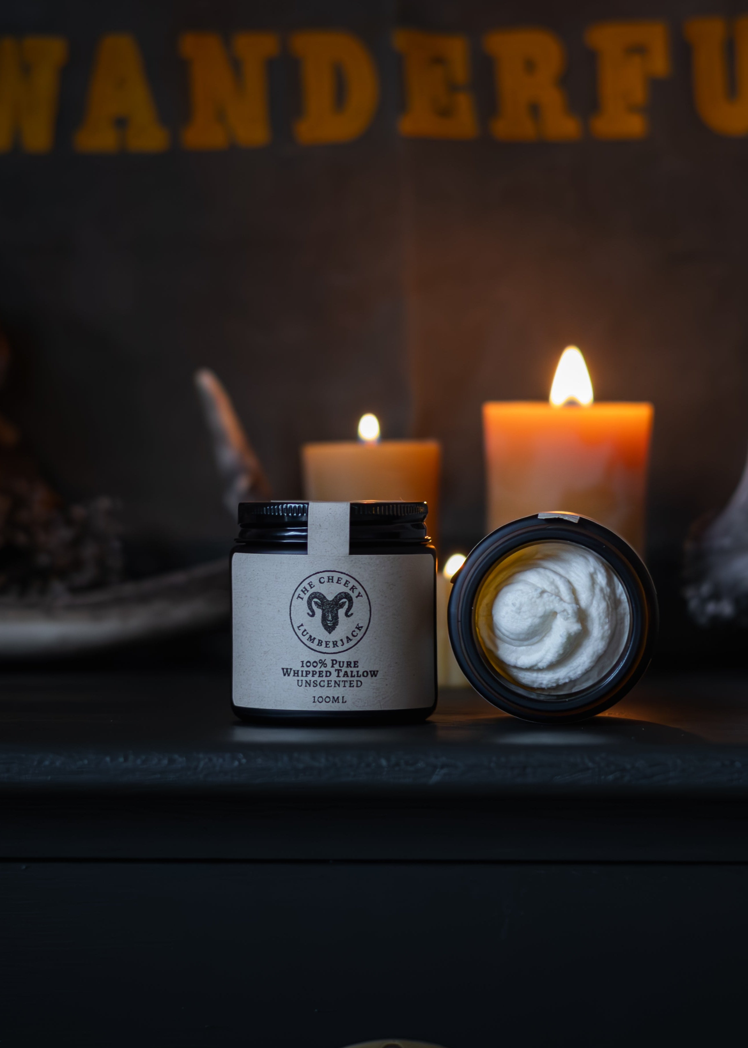 Tasmanian Beeswax Candle and Tasmanian Pure Whipped Beef Tallow on a dark surface with Deer antlers and 'WANDERFUL' text in the background