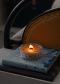 Vintage Crystal Tasmanian beeswax candle on a book with a blurred background
